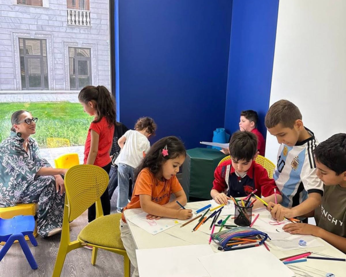 Children drawing together during a therapy session at Armav Center.